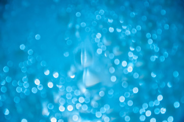 Abstract glitter light blue bokeh background