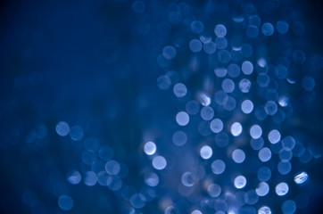 Abstract glitter dark blue bokeh background