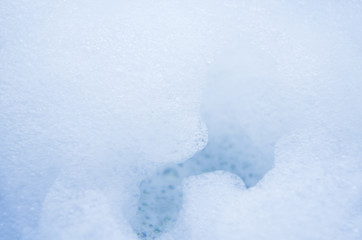 Fototapeta na wymiar Abstract background of white foam bubbles close up