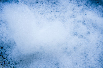 Abstract background of white foam bubbles close up