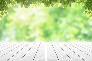 Empty wooden table with party in garden background blurred.