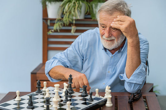 Elderly playing chess in nursing home for leisure