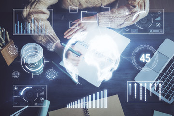 Forex graph on hand taking notes background. Concept of research. Double exposure
