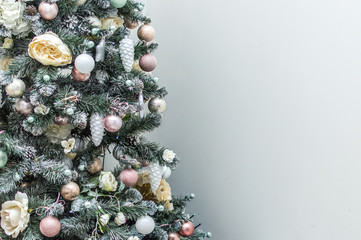 Christmas tree with Christmas decorations on a gray background. Place for text. New Year card....