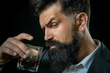 Bearded man holding whisky cocktail in glass - close up portrait. Alcohol Drink.