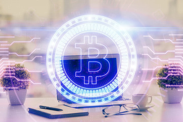 Double exposure of blockchain and crypto economy theme hologram and table with computer background. Concept of bitcoin cryptocurrency.