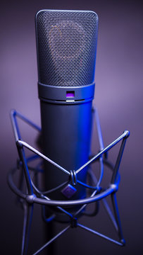 studio condenser microphone, with gradient background and blue light