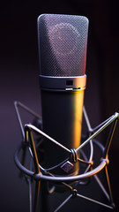 studio condenser microphone, with gradient background and amber light
