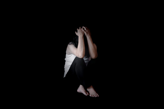 Young woman sitting on floor in dark room, depressed woman, Stop violence against women,International women's day photos