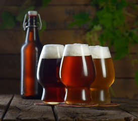 Beer. Beer bottle and glass on a wooden background