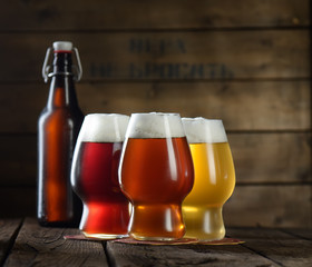 Beer. Beer bottle and glass on a wooden background