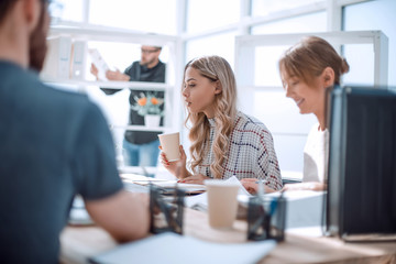 two young women sitting at the office table