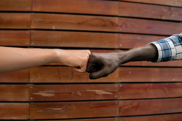 hands of afro american and european men, unity concept