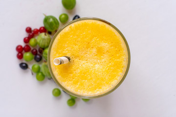 close up macro of fresh summer cooling fruit smoothie in glass with straw