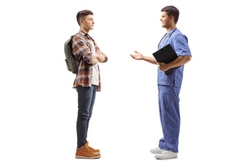 Male doctor in a blue uniform talking to a male student