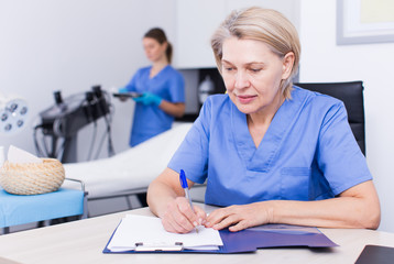 Cosmetologist working with documents