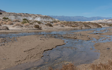 View of Salt Creek from its famous wooden footbridge, located in Death Valley National Park, California during spring day.