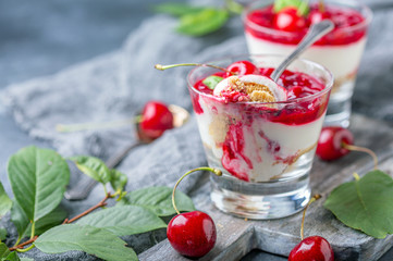Light cheesecake with cherry jelly in a glass.