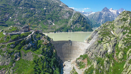Dam at the glacier lakes in the Swiss Alps - aerial view