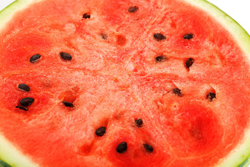 Half slices of tasty and ripe red watermelon on a white background, isolated texture of juicy pulp of ripe red watermelon with seeds