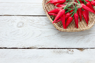 Chili pepper on white wooden background