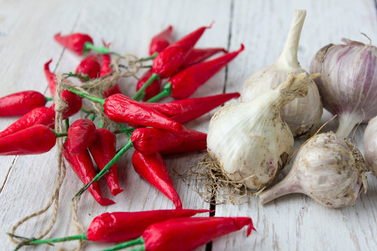 Chili pepper and garlic on a light wooden background