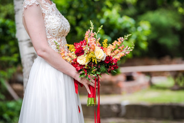  boho wedding bouquet made of red and yellow mixed flowers