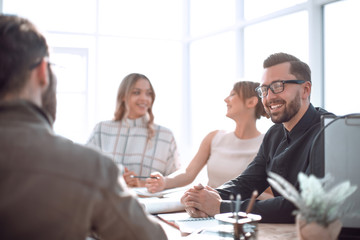 smiling businessman at a working meeting in the office