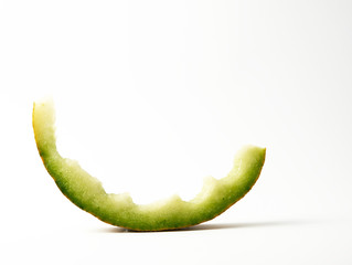 eaten stub of melon on a white background