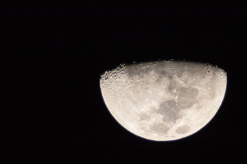 Naklejka premium Beautiful moon on dark sky. Half Moon refers to the two lunar phases commonly known as first quarter and last quarter.