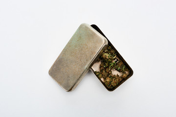 top view of Marijuana Buds in metal box on white background