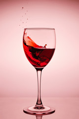 Red wine splash in the wineglass