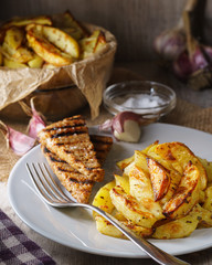 Baked potatoes on the plate with bread slices