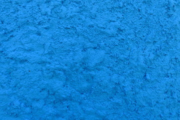 Fototapeta na wymiar Détail de surface granuleuse de mur bleu.