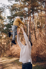Family in a summer park. Father in a brown sweater. Cute little son