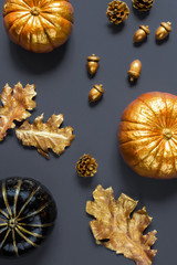 Flat lay autumn composition.Pumpkins, leaves, acorns, golden cones on a gray background Frame copy space. Template fall harvest thanksgiving halloween anniversary  cards Top view