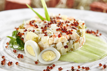 Olivier Salad or Russian Salad with Salmon and Red Caviar