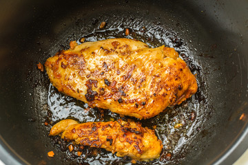 Beautiful chicken breast fillet marinated in hot spices cooked roasted in slow cooker.