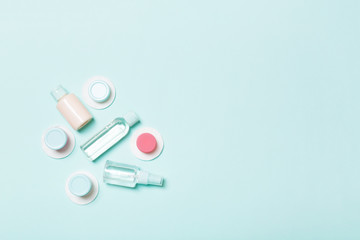 Top view of means for face care: bottles and jars of tonic, micellar cleansing water, cream, cotton...