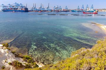 A large container ship is loaded in the cargo port of Malta.