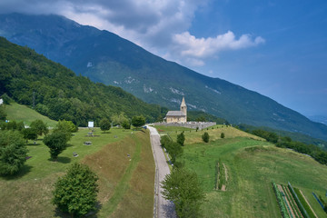 Fototapeta na wymiar Aerial photography. Panoramic view of the Alps north of Italy. Trento Region. Great trip to the Alps. Cemetery is located on a hill.