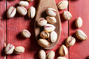 pistachios over wooden bowl