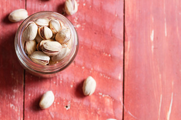 pistachios over wooden bowl