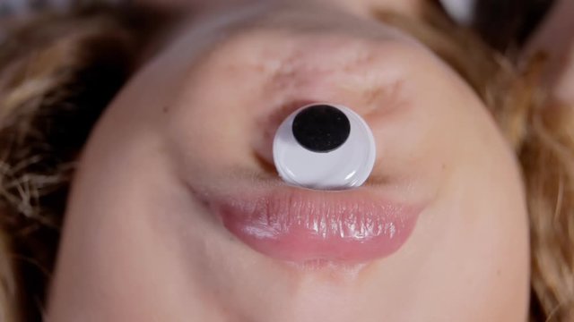 A funny cyclops face, obtained by putting one single googly eye on the chin of a little girl and shooting upside down. Hilarious comedic shot.