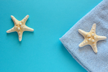 Summer holiday concept with starfish on the blue background.