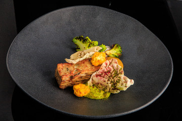 tasty restaurant meat dish with sauce and vegetables