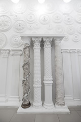 Obraz premium Decorative item made of white plaster on ceiling and wall. Beautiful ornament and relief stucco interior