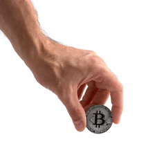 Closeup man's hand holding silver Bitcoin, isolated on white background. Digital currency money trading with cryptocurrency, coin with profit, finance concept