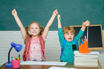 Back to school and happy time. First time to school. Educational process. Kids school. Happy cute clever boy and cute little girl with book. Kids excited.