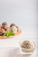 vegetarian food, energy balls of walnuts, dates, prunes, cranberries, honey with sesame
